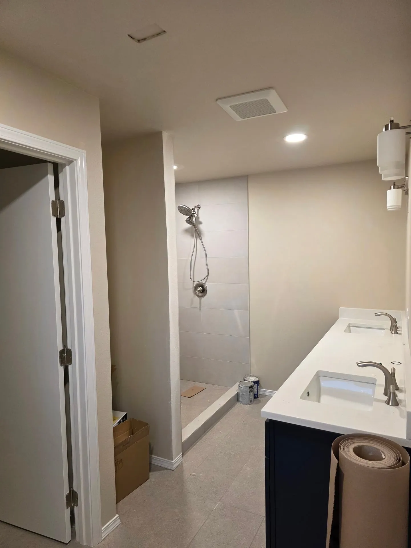 New bathroom in a Vancouver WA addition with a recessed light, exhaust fan, walk-in shower and double vanity