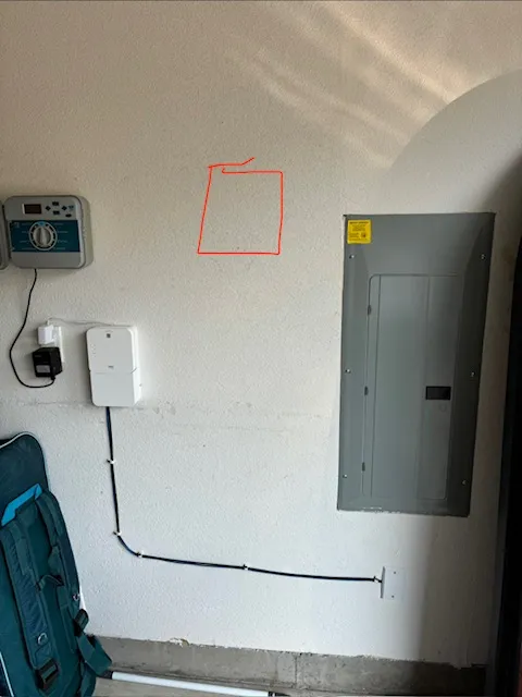 Garage wall of a Camas WA home before the EV charger install, with the mounting location marked in red beside the existing electrical panel