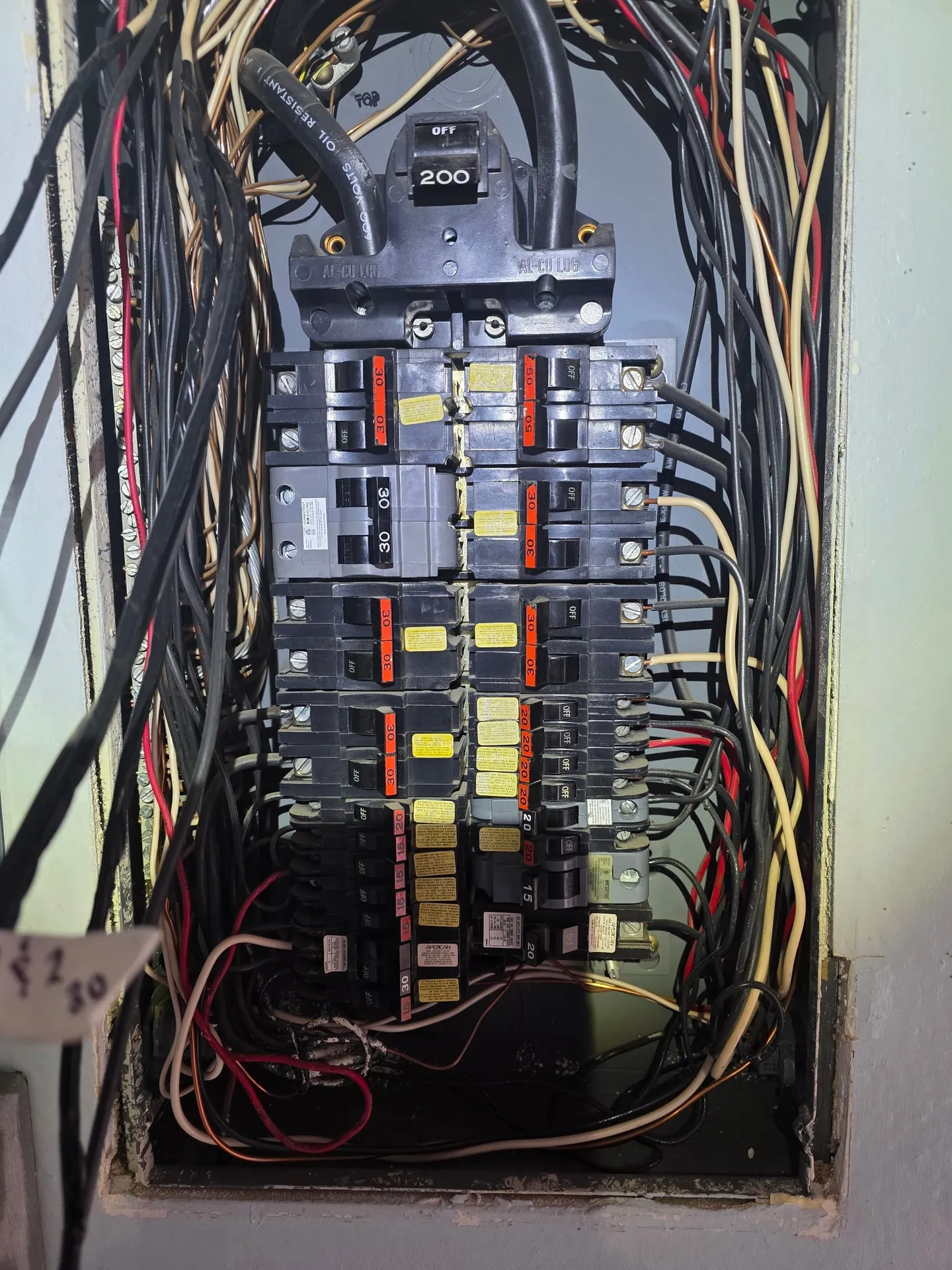 Interior of the old Federal Pacific Stab-Lok panel in a Washougal WA home showing crowded branch circuit conductors and the distinctive Stab-Lok breakers before removal