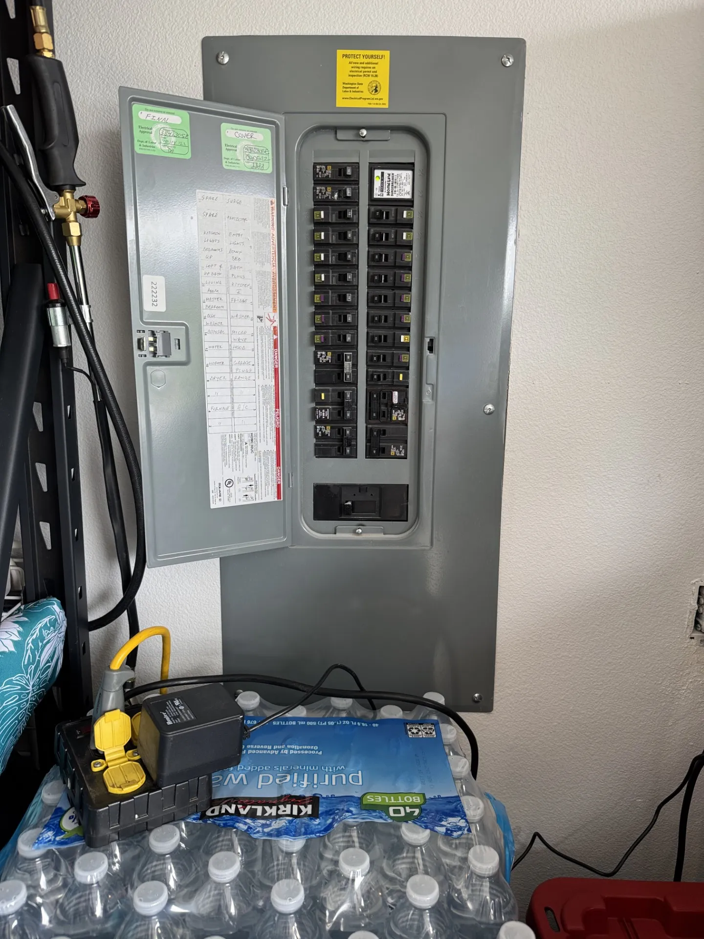 Open Square D Homeline electrical panel in a Ridgefield WA garage with green L&I permit stickers and a labeled directory, where the new EV charger circuit was landed