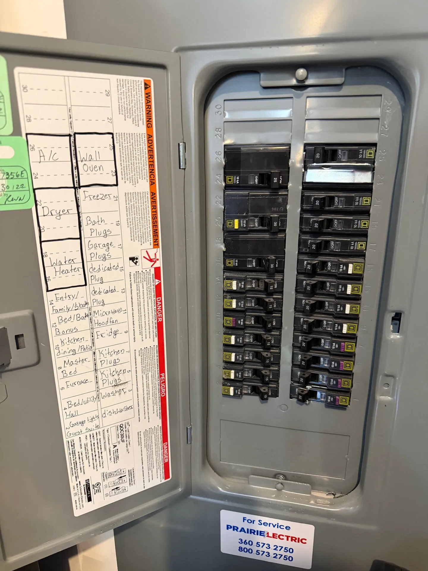 Open Square D QO electrical panel in a 2022 Vancouver WA garage with a labeled circuit directory and a Prairie Electric service sticker, showing the open spaces used for the new EV charger circuit