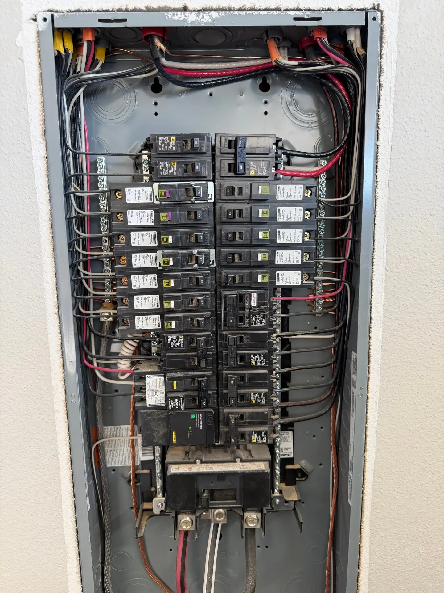 Open Eaton electrical panel in a 2022 Vancouver WA home with a dense row of breakers and open spaces available, where the new dedicated EV charger circuit was landed