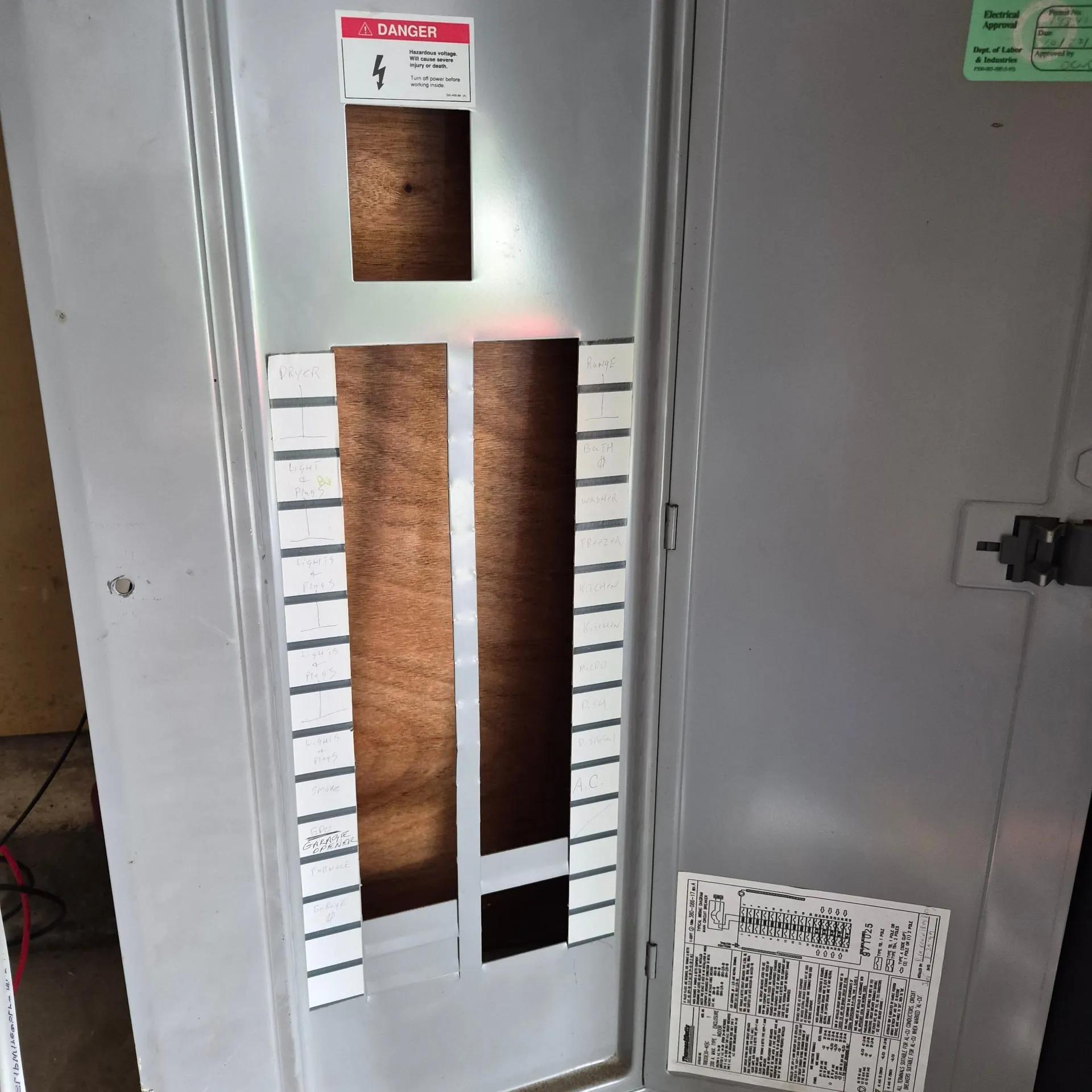 Electrical panel with its cover and circuit directory at a Vancouver WA home, where a tandem breaker was used to free up the slots needed for the two new dedicated circuits