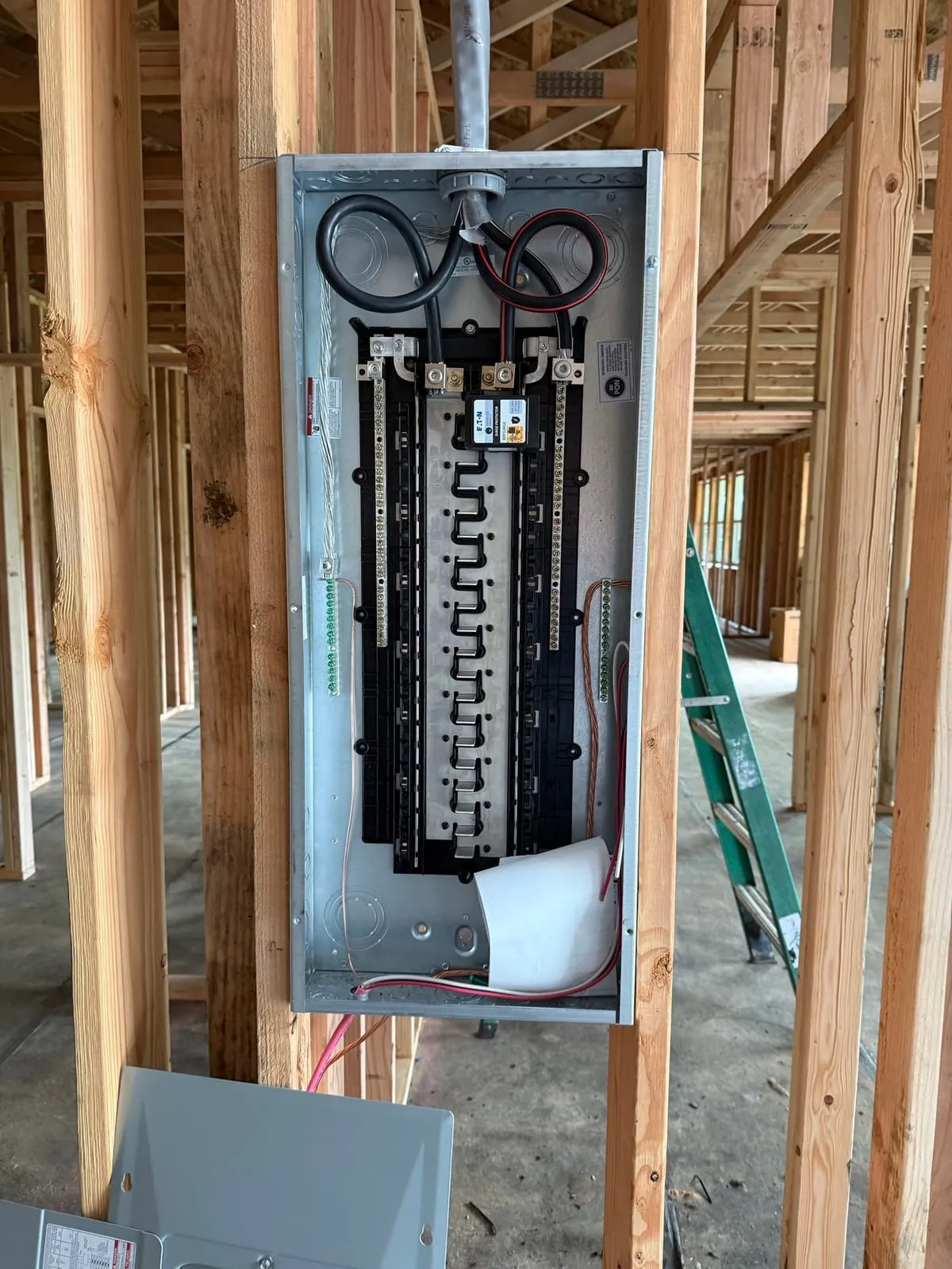 40/80-space Eaton MLO main lug panel with integrated whole-house surge protector, mounted during the rough-in phase of a Vancouver WA new construction home
