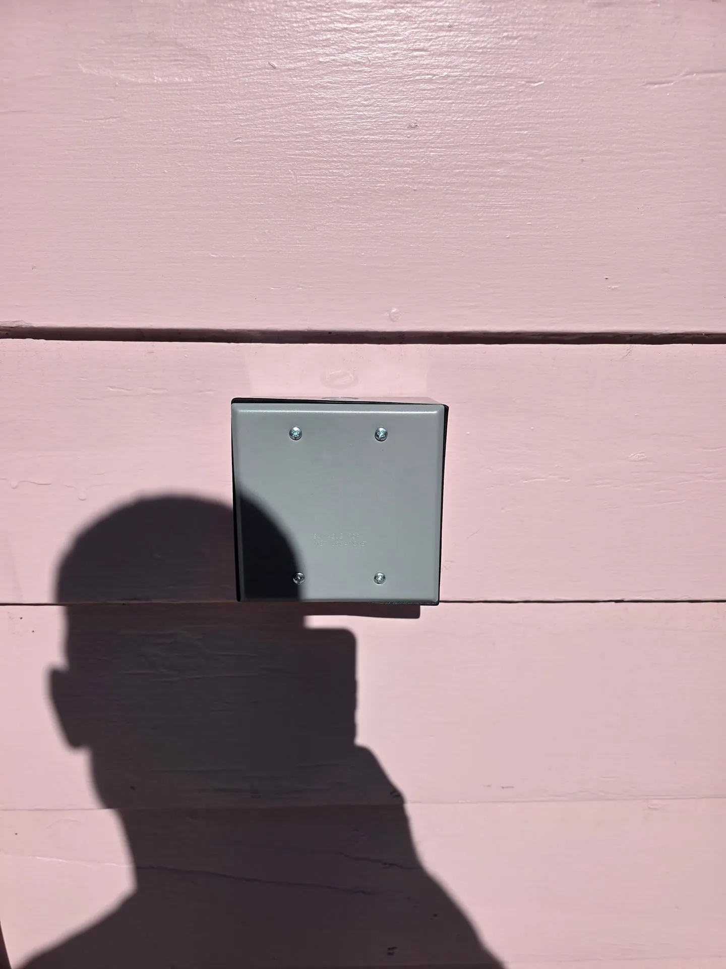 Two-gang weatherproof box on pink lap siding at a Woodland WA home where a 50-amp EV charger circuit ends