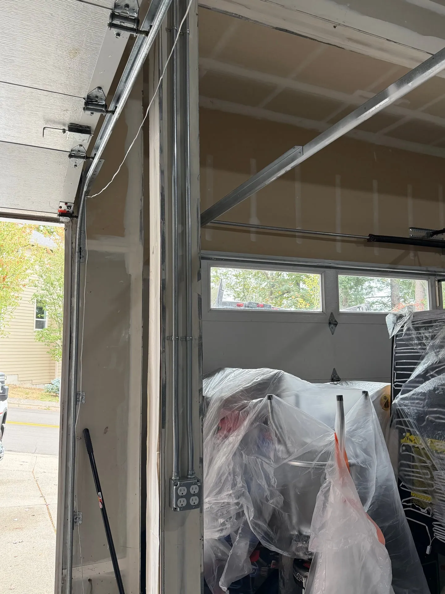 EMT conduit running down the garage wall beside the overhead door to a new quad outlet in a Washougal WA garage