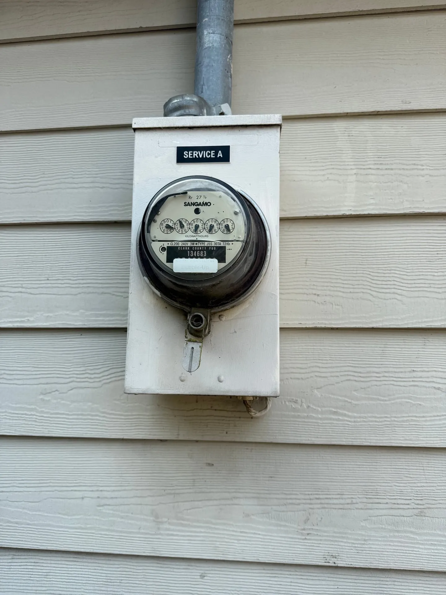 Meter base on the siding of a Camas WA property with an engraved black and white phenolic label reading SERVICE A fixed above the meter socket