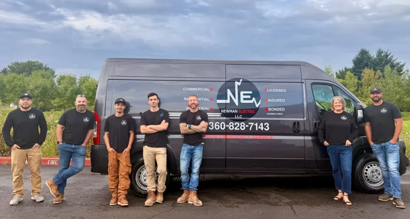 The Newman Electric crew standing in front of their branded service van in Vancouver, WA