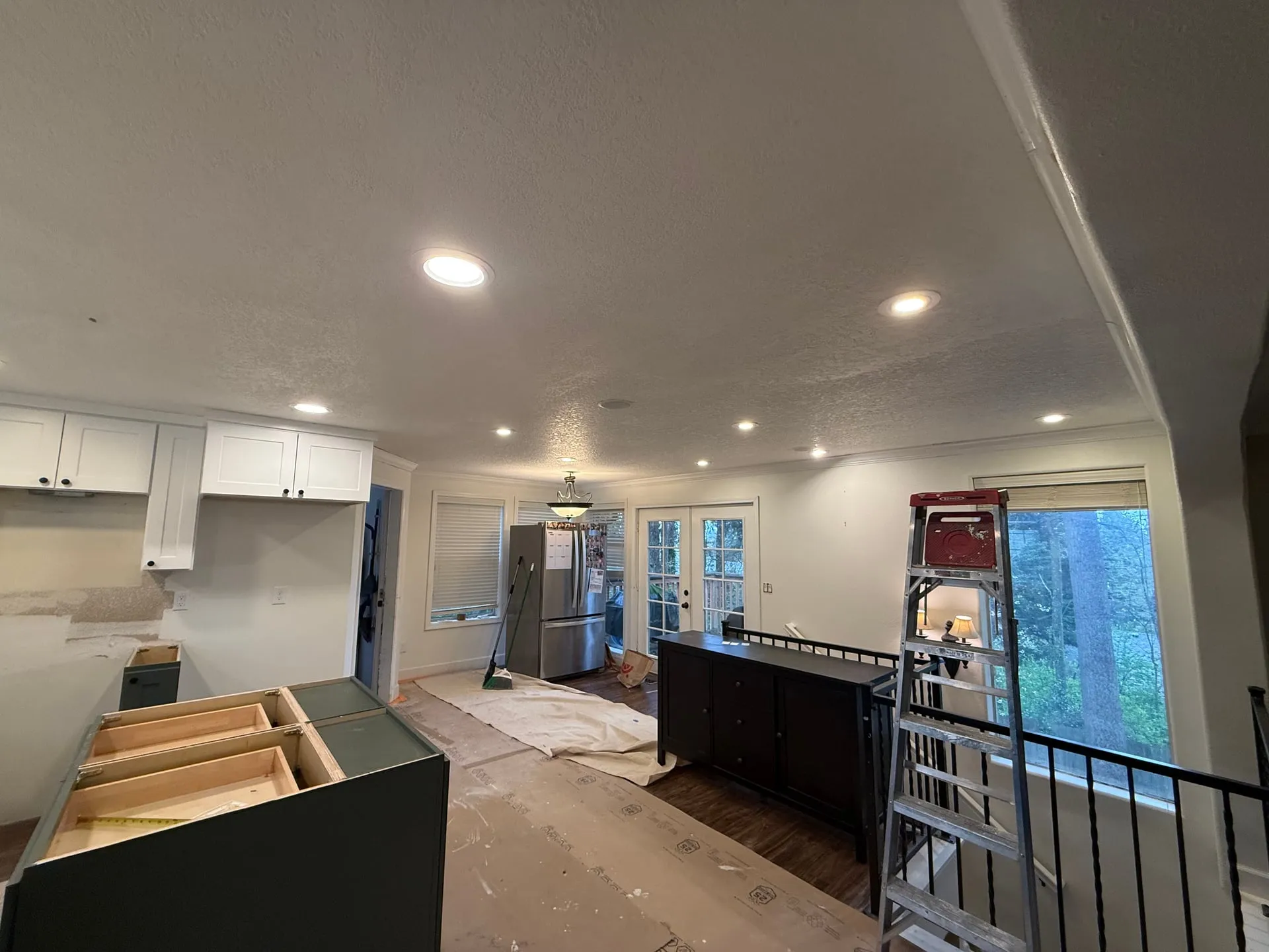 Canless LED downlights continuing from a Vancouver WA kitchen through into the adjoining dining space, showing the matched spacing across both rooms