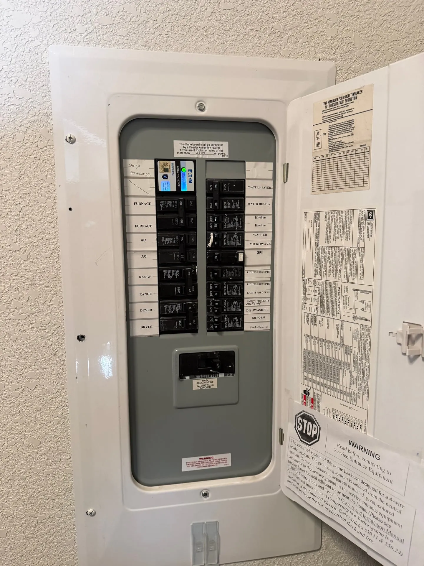 Open electrical panel inside a manufactured home in Orchards, Vancouver WA with a printed circuit directory on the door and breakers labeled for the furnace and air conditioning circuits