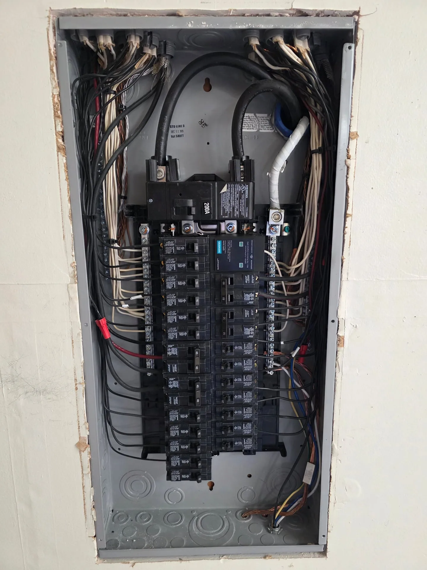 New electrical panel in a Hazel Dell home in Vancouver WA with the dead front removed, showing branch circuit conductors dressed down both sides and landed squarely on the breakers