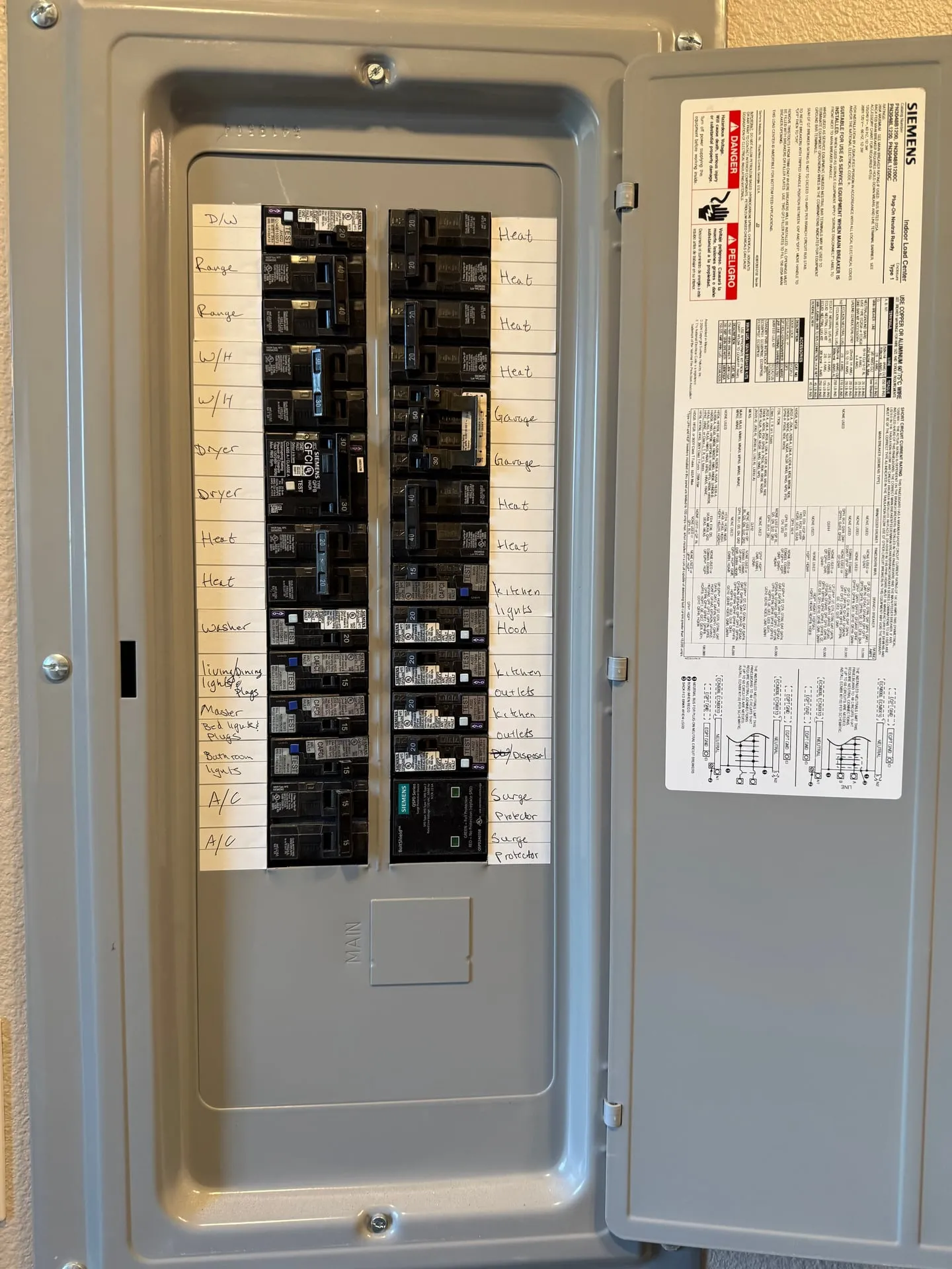 New Siemens electrical panel in a north Vancouver WA home with the door open and a fully handwritten circuit directory listing every branch circuit after the kitchen rewire