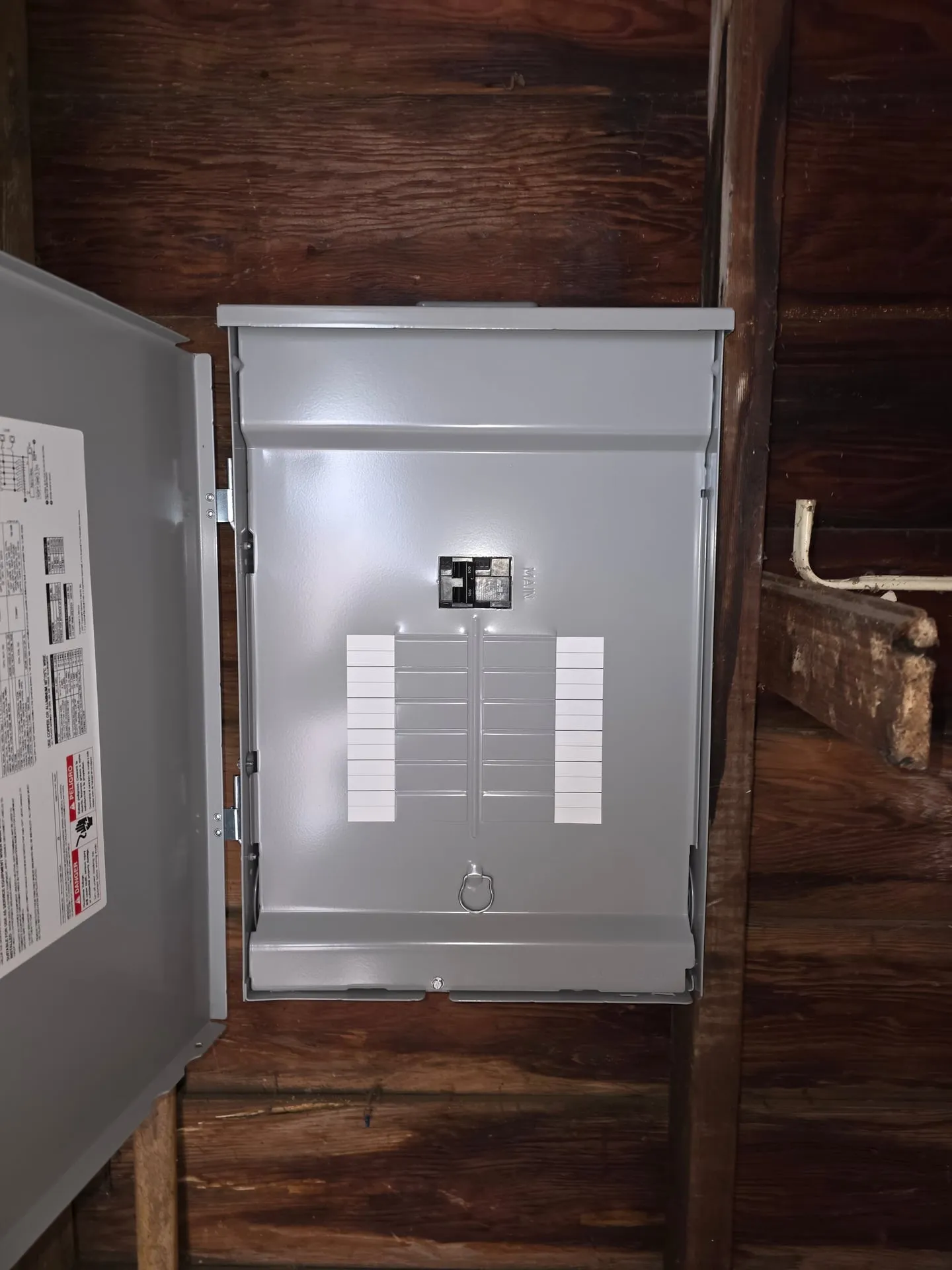 New gray subpanel with a main breaker mounted on the wood wall of a detached garage in Washougal WA