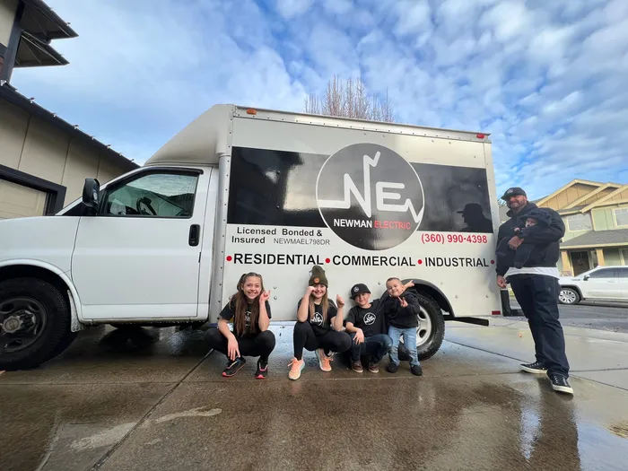 Newman Electric service vans at a commercial job site