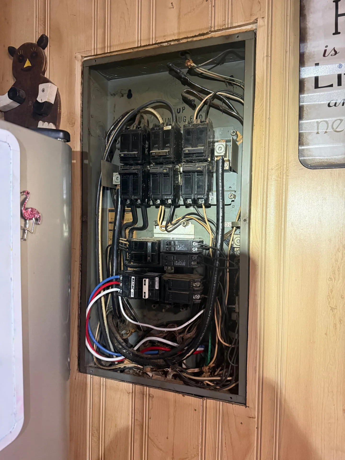 Open electrical panel in a Kelso WA home with the cover off, showing a full row of breakers before tandem breakers made room for a new circuit