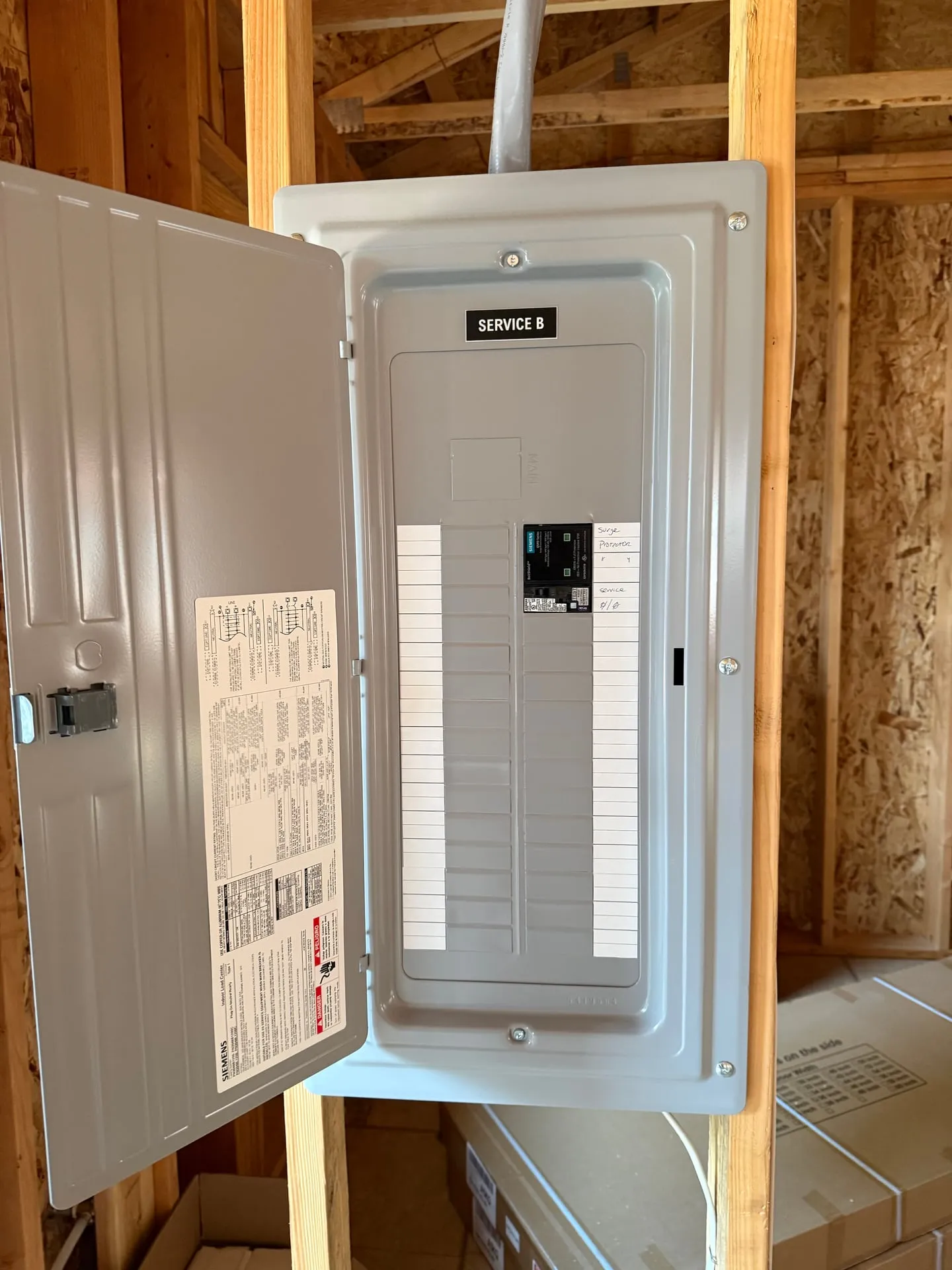 Open electrical panel on a Camas WA property with an engraved phenolic label reading SERVICE B fixed to the dead front above the breakers