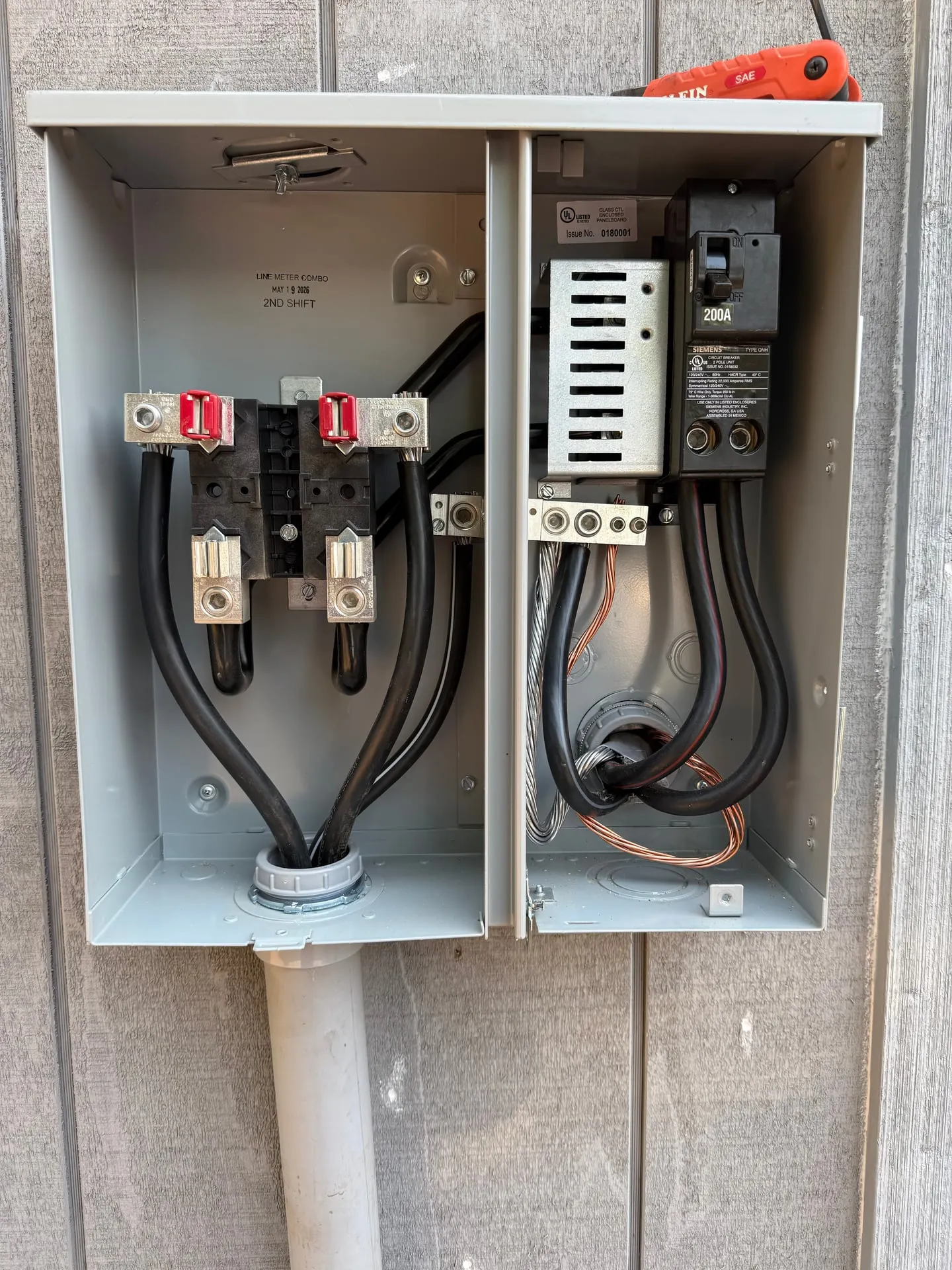 Interior of a service disconnect enclosure on a Camas WA property showing the main lugs, breaker and neutral and grounding terminations