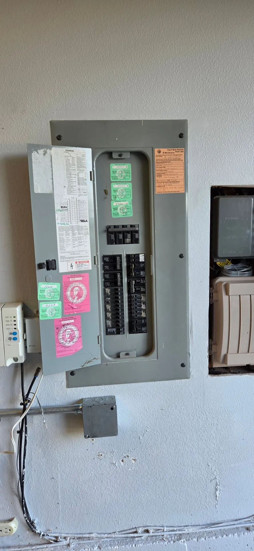 Siemens panel with the cover back on in a Camas WA garage after a 60-amp EV charger breaker was added