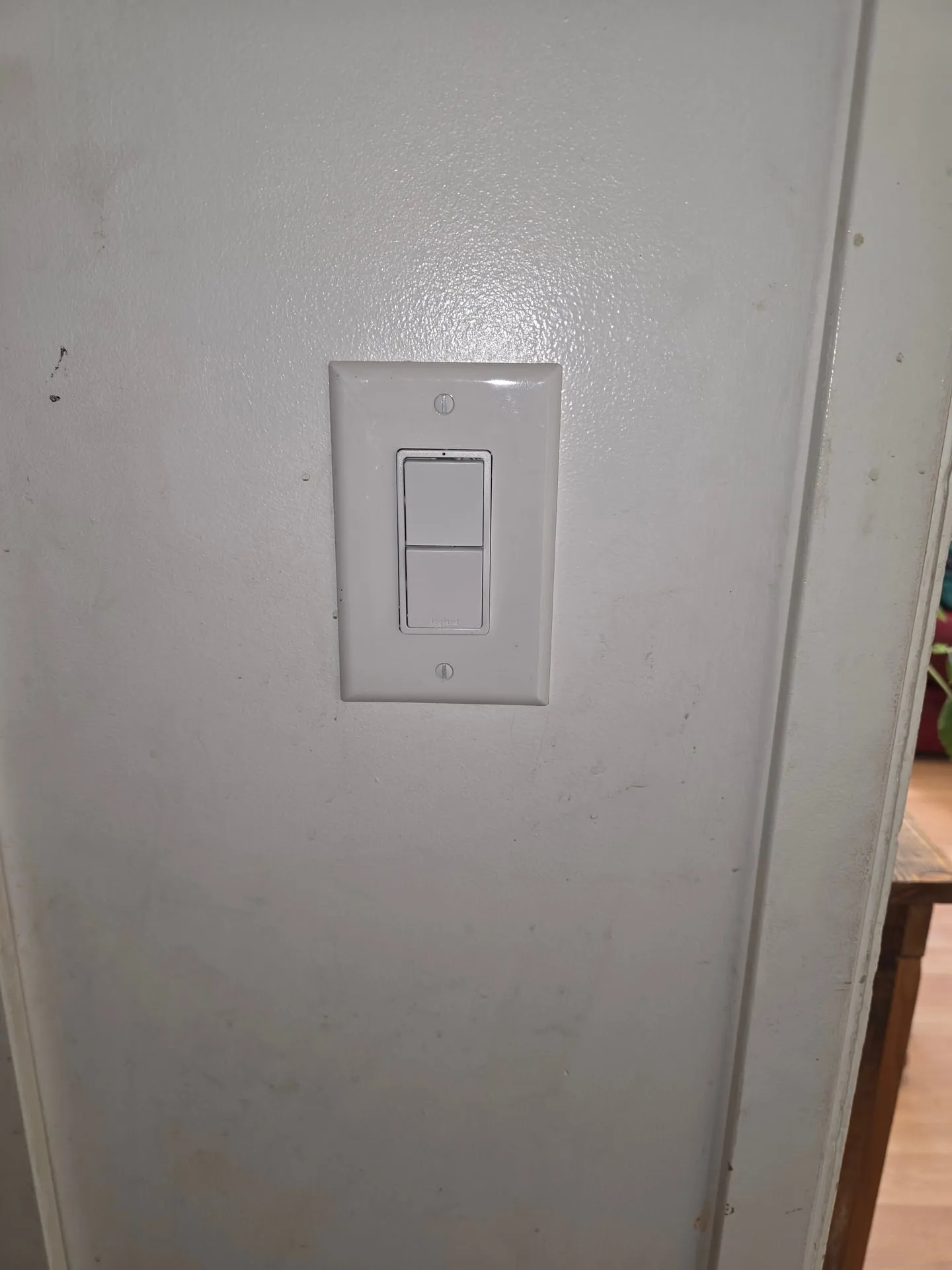 White stack switch with two rockers on a hallway wall in a Woodland WA home controlling the hall light and attic fan