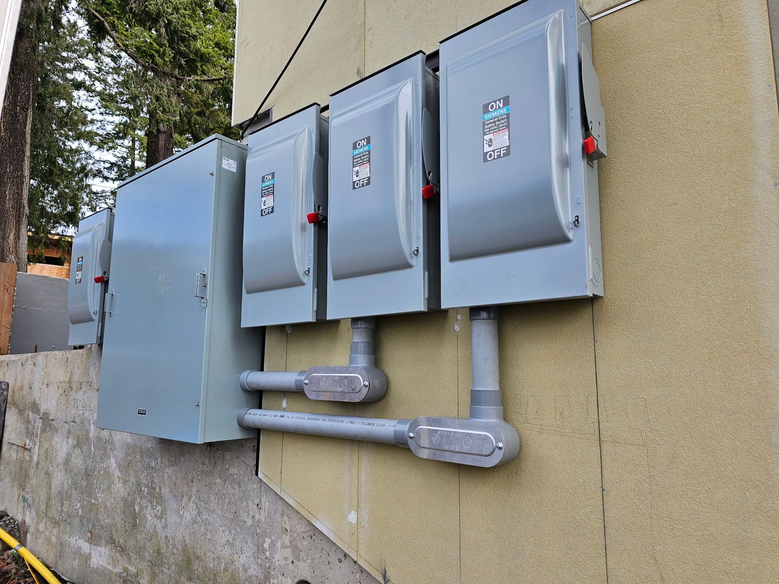 Row of three phase disconnect switches installed by Newman Electric for commercial building